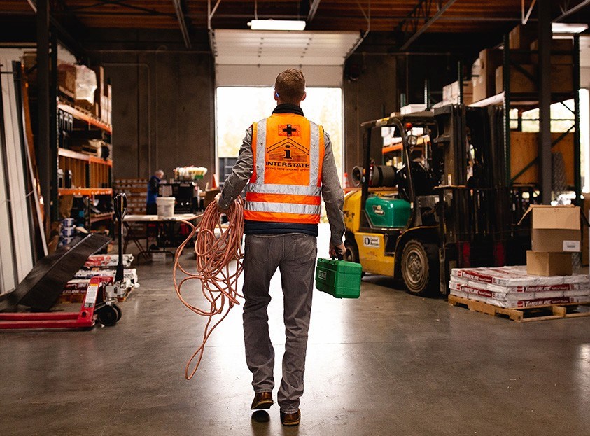 Oregon roof inspector walking to job site